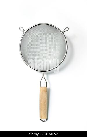 Single Fine Mesh Strainer. Silver colored metalic colander with wooden handle isolated on a white background Stock Photo