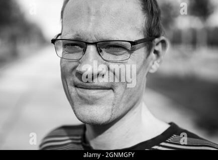 Leuven, Flemish Brabant Region, Belgium - 09 22 2021: Black and white head shot of a forty year old man with beard Stock Photo