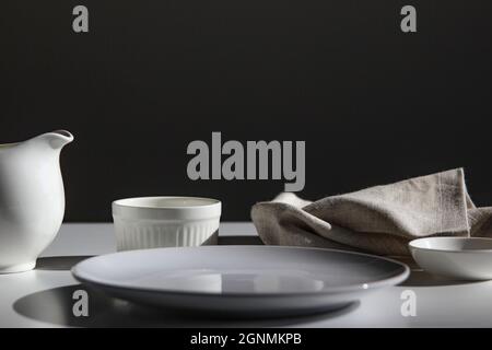 Empty white plate on white stone table, copy space. Stock Photo