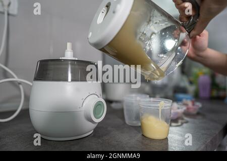 close up of woman hand pouring milk to blender Stock Photo - Alamy