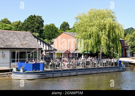 Chester, England - July 2021: People on the terrace of a pub and restaurant on the banks of the River Dee in Chester. Stock Photo