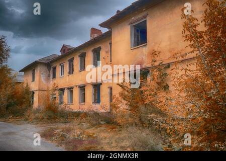 The ruins of a destroyed building in the city. Old abandoned collapsing building. Landscape with the ruins of the old buildings. Stock Photo