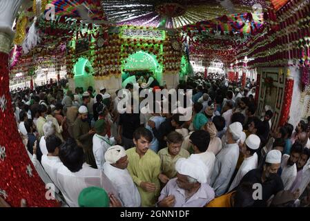 Lahore, Pakistan. 26th Sep, 2021. Sept. 26, 2021 - Pakistani Muslim devotees take part on the annual ''URS'' religious festival at shrine of Sufi Saint Syed Ali bin Osman Al-Hajvery, popularly known as 'Data Ganj Bakhsh' in Lahore. Thousands of people traveled from all over Pakistan to attend the celebrations. During the festival the shrine is lit up with candles, there are donated food for the people and Sufis, who dance and play music for hours. (Photo by Rana Sajid Hussain/Pacific Press/Sipa USA) Credit: Sipa USA/Alamy Live News Stock Photo