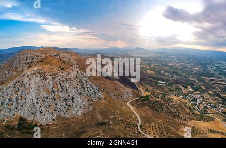 Aerial view of Acrocorinth 'Upper Corinth' the acropolis of ancient Corinth, Greece. It is a monolithic rock overseeing the ancient city of Corinth an Stock Photo