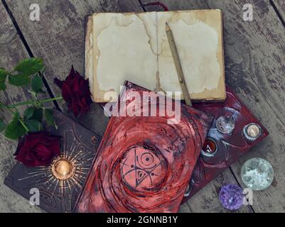 Still life with old decorated book with roses and crystals.  Knowledge concept with empty vintage diary and copy space, top view Stock Photo