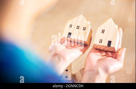 woman select home, house or any accommodation for invest and loan with wood house model for design, business plan for her family and engineer construc Stock Photo