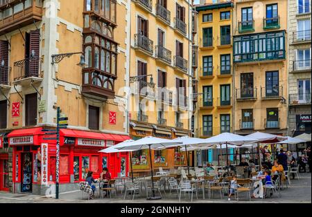 Pamplona, Spain - June 21, 2021: People in street cafes on Plaza Consistorial in the old town or Casco Viejo famous for running of the bulls Stock Photo