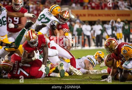 Santa Clara, CA, USA. 26th Sep, 2021. Green Bay Packers' AJ Dillon (28) is  tackled by San Francisco 49ers' Azeez Al-Shaair (51) and San Francisco 49ers'  Emmanuel Moseley (4) after a pass