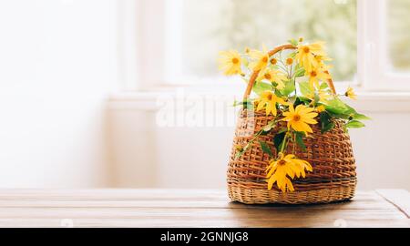 Vase with beautiful sunflower in wicker basket and bottle of orange juice  on wooden table Stock Photo - Alamy