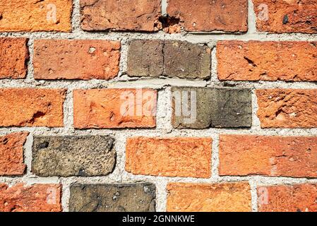 Brick wall texture, old orange-red and dark bricks Stock Photo