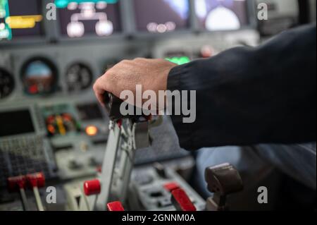 Engine thrust levers. The pilot's hand holds the levers. Stock Photo
