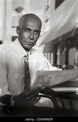 African American businessman with newspaper MR - model released Stock Photo