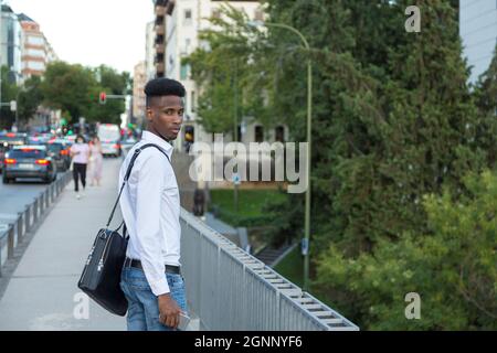 young african american businessman with briefcase posing on the street Stock Photo