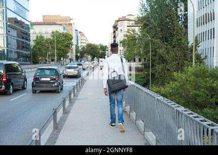 young african american businessman with briefcase walking down the street Stock Photo