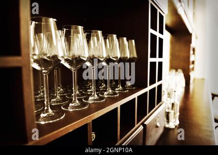 Empty wine glasses in row. Shallow depth of field. Focus on foreground Stock Photo
