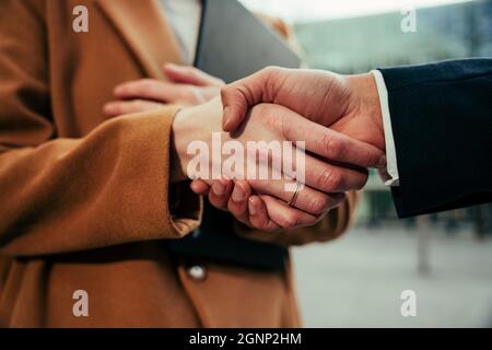 Close up of mixed race colleagues shaking hands making agreements before business meeting Stock Photo