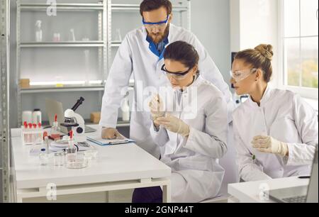 Male and female scientists working in laboratory, doing medical research Stock Photo