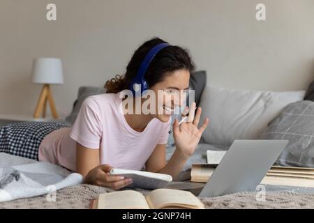 Smiling female student have webcam lesson at home Stock Photo