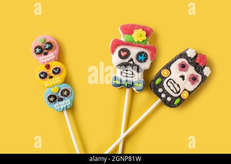 Candy Mexican skull lollipops isolated on yellow background Stock Photo