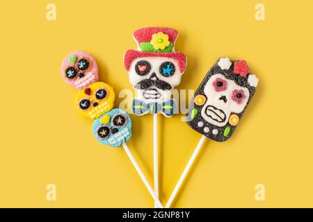 Candy Mexican skull lollipops isolated on yellow background Stock Photo