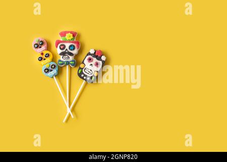 Candy Mexican skull lollipops isolated on yellow background Stock Photo