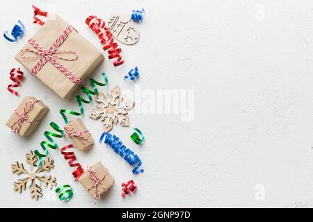 Holiday flat lay with gift boxes wrapped in colorful paper and tied decorated with confetti on colored background. Christmas, Birthday, Valentine and Stock Photo