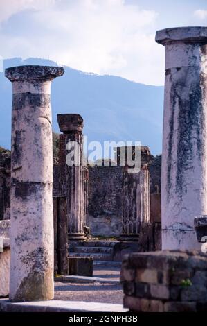 In the shadow of Mt Vesuvius ancient Doric fluted columns are preserved at Pompeii Archaeological Park in Southern Italy. Stock Photo