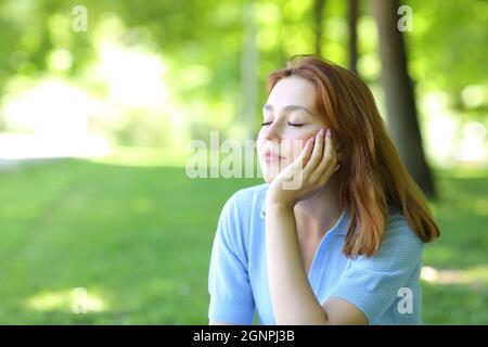Beautiful woman relaxing sitting in a park Stock Photo