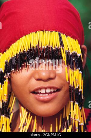 Philippines, Mindanao; Woman of the T'boli tribe drinking water from a ...