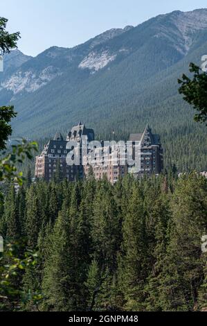 The Fairmont Banff Springs Hotel surrounded by evergreen trees in Banff ...