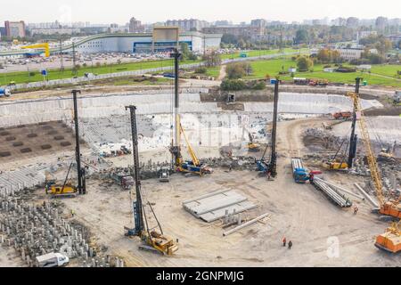 Huge excavation and foundation construction, drilling piles in urban development, aerial view Stock Photo