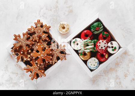 Christmas Cookie Boxes. Cardboard boxes with donuts and gingerbread as a gift. Top view, blank space Stock Photo