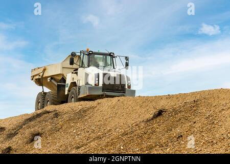 Articulated Dump Truck with load of shingle aggregate Stock Photo