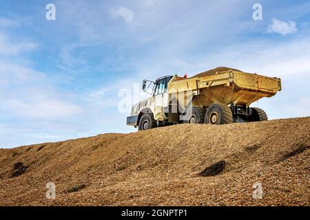 Articulated Dump Truck with load of shingle aggregate Stock Photo