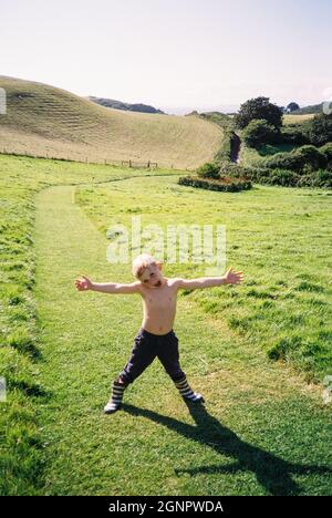 Four year old boy in fields near Hope Cove, Kingsbridge, Devon, England, United Kingdom. Stock Photo