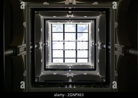 Interior of the small courtyard covered with glass in an old renovated tenement house in Spain Stock Photo