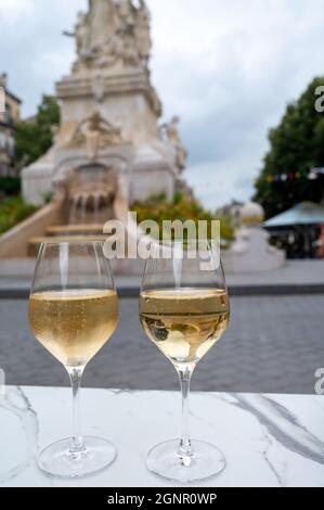 Drinking of brut champagne sparkling wine in street cafe with view on old central part of city Reims, Champagne, France Stock Photo