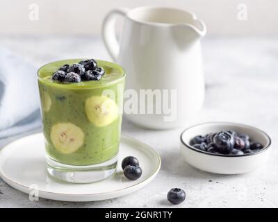 chia pudding with green superfood powder, banana, almond milk, blueberry Stock Photo