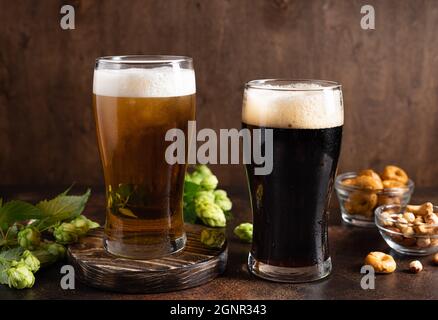 different sorts of craft beer in frosty glasses and snacks on table Stock Photo