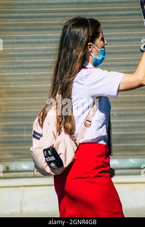 Seville Spain September 22, 2021 Young woman working like a guide tour with tourists in the street during the coronavirus outbreak hitting Spain Stock Photo