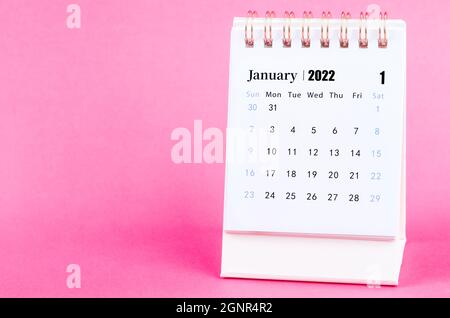 January 2022 desk calendar on pink background. Stock Photo