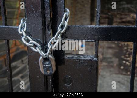 A lock and chain on Metal Fence that links of a gate. 7449605 Stock Photo  at Vecteezy
