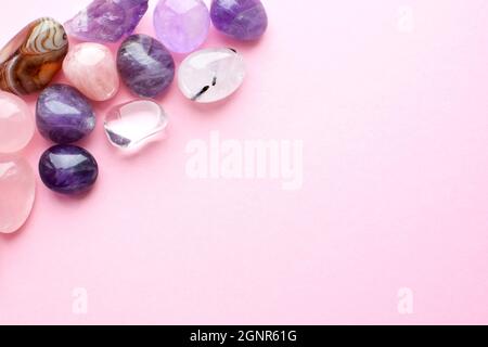 Beautiful gemstones  on a pink background. Amethysts and rose quartz. Large crystals of semi-precious stones. Stock Photo