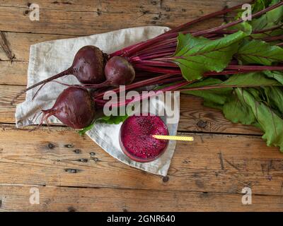 Fresh smoothie squeezed  beetroot juice in a glass on a wooden surface  Healthy eating, detox, dieting and vegetarian concept. Stock Photo