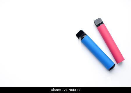Two electronic cigarettes on a white background. Place for your text. Stock Photo