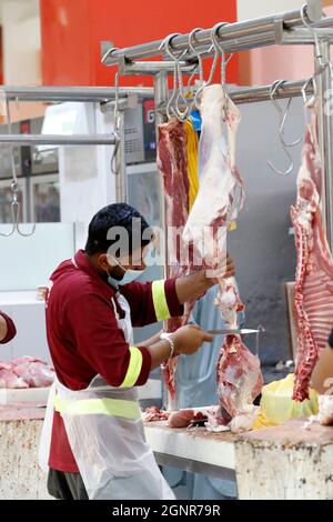 Butcher working in Dubai meat market in Deira.   United Arab Emirates. Stock Photo