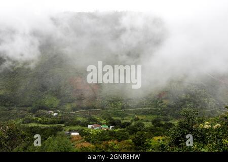 Mist and houses in Intag valley, Ecuador Stock Photo