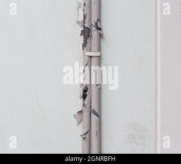Broken outdoor air conditioner ducts on building wall Stock Photo
