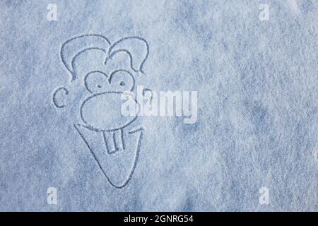 Painted by child primitive little men holding hands. Picture on the snow. Happy winter season. Stock Photo