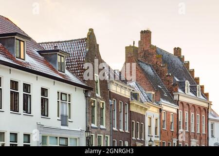 Sunset winter view of snow covered historic houses in the Dutch city center of Doesburg, The Netherlands Stock Photo